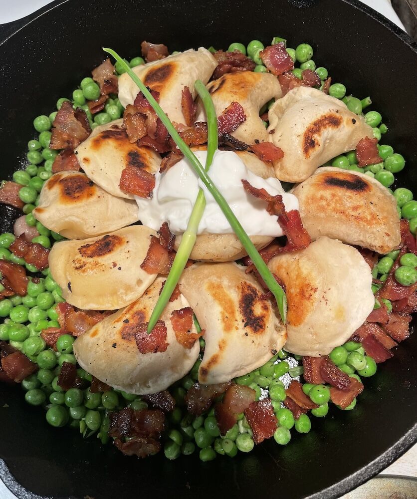 Perogies on green vegetables